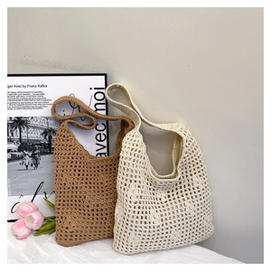Detailed macro view of handcrafted woven crochet tote bags in brown and beige colors