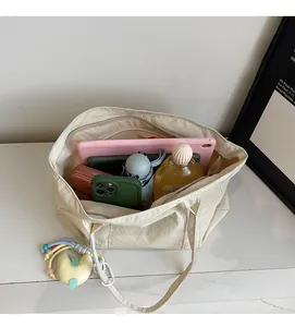 Interior view showing large capacity of the canvas tote bag with various daily essentials