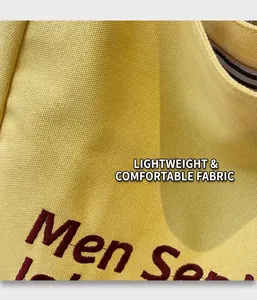 Close-up of yellow canvas fabric with detailed red Men Sen letter embroidery texture
