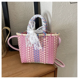 Detail of pink and white woven mini square bag with lace bow and blue accents