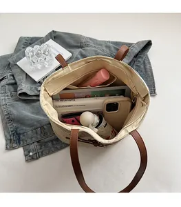 Interior view of large straw tote bag showing spacious capacity for tablets and essentials
