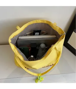 Top view of bright yellow canvas tote bag showing spacious striped interior and capacity
