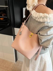 Pink pebbled leather large tote bag with gold twist lock and heart charm decoration