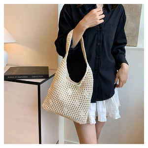 Detail of cream crochet tote bag featuring intricate hollow mesh and 3D floral accents