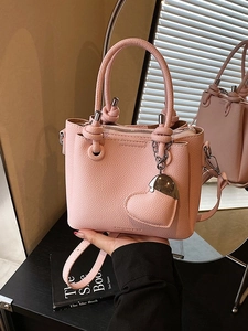 Chic pink lychee texture bucket bag with round handles and cute heart-shaped charm