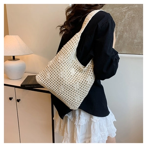 Detail shot of beige crochet hollow bucket bag showing intricate woven mesh pattern