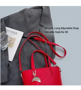 Detail of red bucket bag featuring lychee texture and a silver heart-shaped pendant