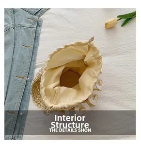 Internal structure of straw bucket bag with drawstring liner and hollow charm detail