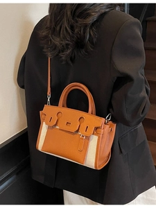 Minimalist orange and beige leather canvas crossbody bag shown on a model