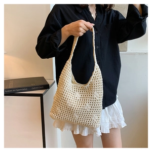 Detailed macro view of beige crochet knit bucket bag showing mesh weaving pattern