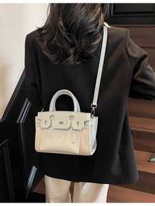 Minimalist light blue and beige patchwork leather tote bag with a cross-body strap