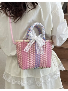 Pastel woven crossbody bag with white lace bow and dual handles for spring fashion