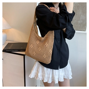 Detail of beige hollow out crochet shoulder bag with cloth lining and woven mesh texture