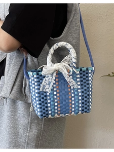 Colorful woven crossbody bag with striped design and elegant lace ribbon handle