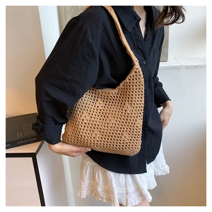 Detail of hand-woven hollow knit tote bag showing breathable mesh texture on the shoulder