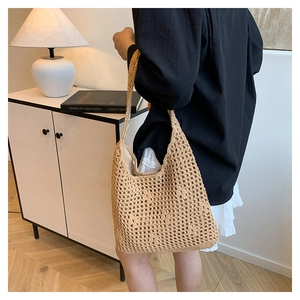 Detailed view of the hollow woven bucket bag showing natural texture and handle