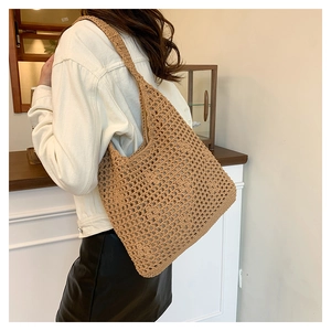 Detail of hand-woven brown crochet tote bag showing spacious knit mesh pattern and texture