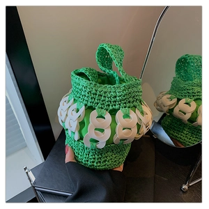 Detail of green and white hand-woven bucket bag with circular chain link design