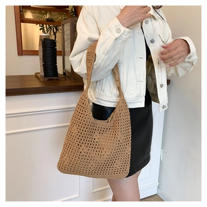 Detail of hand-woven hollow mesh shoulder bag in light brown showing crochet texture