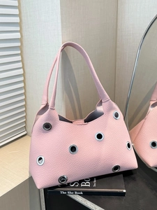 Pink lychee grain leather shoulder bag with decorative silver metal eyelets for women