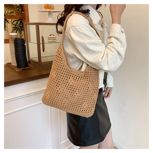 Close-up of light brown crochet shoulder bag with hollow knit texture and casual design