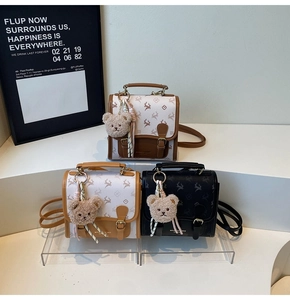 Detailed display of vintage mini backpacks with metal buckles and cute teddy bear charms