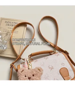 Detail of vintage cream backpack with brown deer print and plush bear keychain