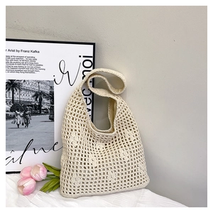 Close-up of hollow crochet bucket bag showing intricate knit pattern and fabric lining