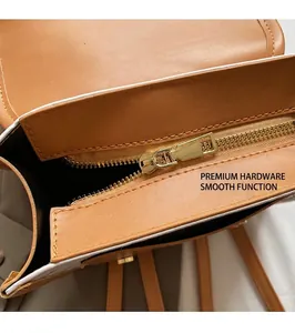 Detail shot of golden metal zipper and smooth stitching on brown leather backpack