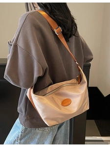 Minimalist beige oxford nylon dumpling crossbody bag with adjustable brown strap