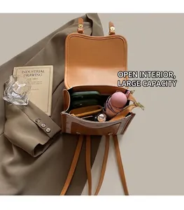 Internal view showing spacious storage for phone and umbrella in brown vintage backpack