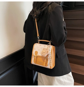 Detail of vintage women's backpack with deer pattern and hanging plush bear charm accessory