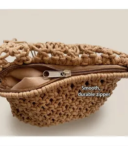 Close-up of the smooth metal zipper and intricate woven texture of the bohemian beach bag