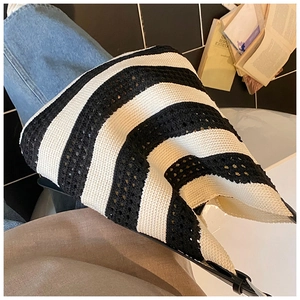 Detail of black and white striped crochet tote bag with adjustable leather shoulder strap