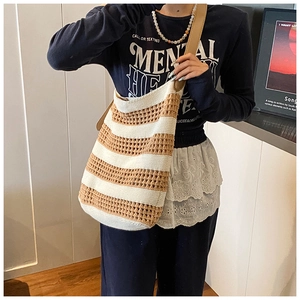 Detail of the woven texture and contrast stripes on the stylish beach tote bag