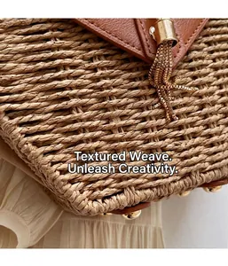Detail of woven straw texture with brown leather flap and golden tassel on summer bag