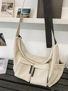 Large beige messenger bag with double pockets and adjustable shoulder strap for women
