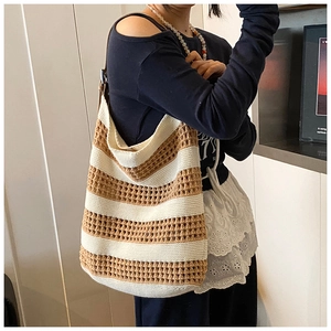 Close-up of beige and camel striped crochet knit hobo bag with textured mesh detail