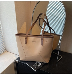 Detail of high-quality lychee grain leather tote bag with elegant brown trim and handle
