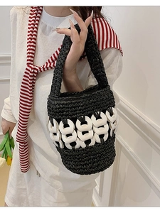 Handmade black woven straw bucket bag with white ring chain detail for summer beach fashion