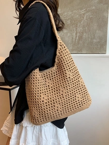 Summer hollow woven bucket bag in khaki crochet style shown on a shoulder model
