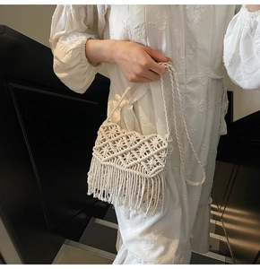 Détail d'un sac tissé main blanc avec des franges denses et un style bohémien chic