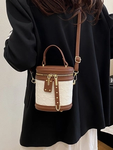 Minimalist caramel and beige bucket bag with top handle and adjustable strap for women
