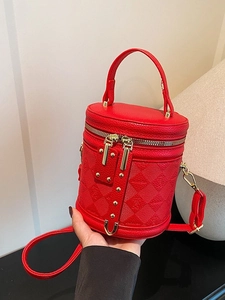 Chic red lychee leather bucket bag with embossed patterns and gold rivet details