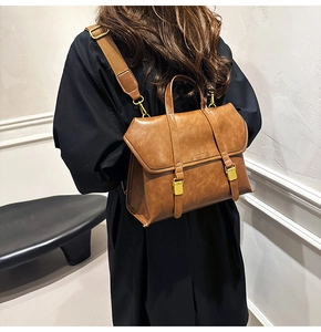 Brown vintage PU leather backpack with gold buckle and adjustable strap shown on model