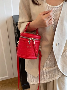 Fashionable red bucket handbag with textured rhombus embossing for stylish women commuting