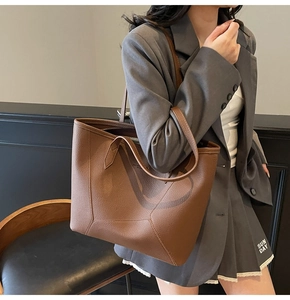 Detail of caramel brown pebble leather tote bag with unique geometric stitching on the side