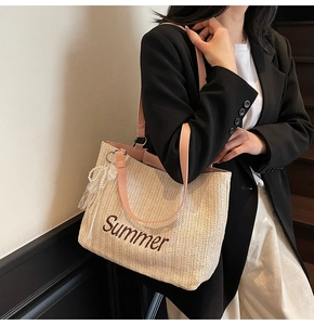 Detail of Summer embroidery on straw tote bag with pink leather strap and pearl charm