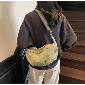 Light olive nylon crescent crossbody bag with adjustable wide strap and side pleat details