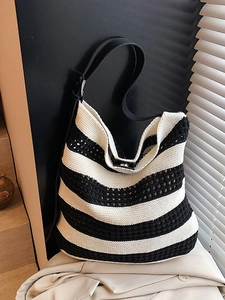 Minimalist black and white striped knit tote bag with black leather shoulder strap